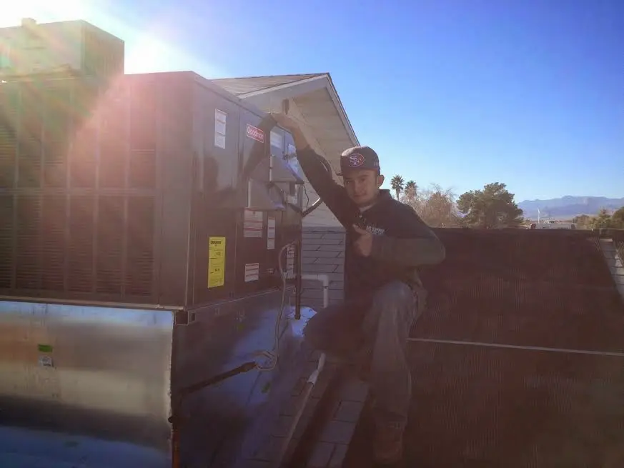 HVAC technician performing Air Duct Cleaning on a rooftop unit in La Mirada